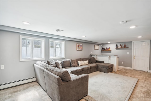 living area featuring bar, a baseboard heating unit, and recessed lighting
