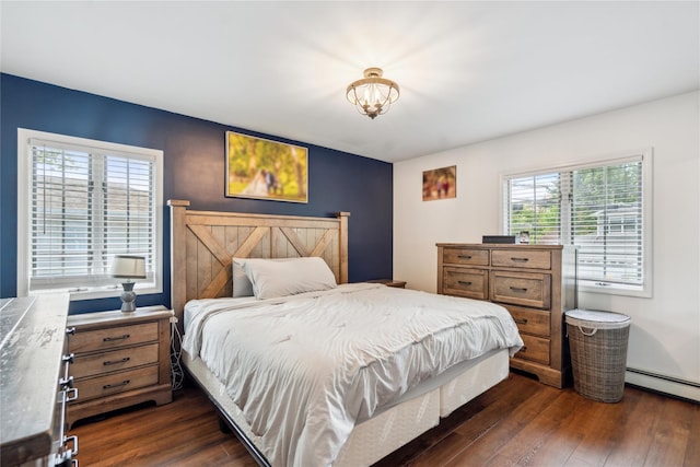 bedroom featuring dark wood finished floors, a chandelier, and a baseboard radiator