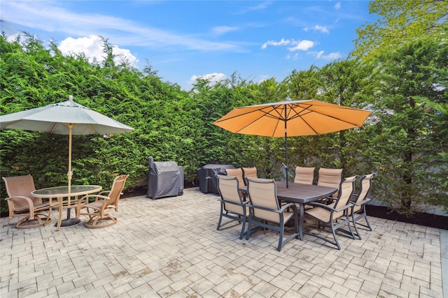 view of patio / terrace featuring outdoor dining area and a grill