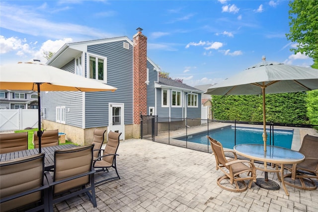 view of swimming pool featuring outdoor dining space, a patio area, and a fenced backyard