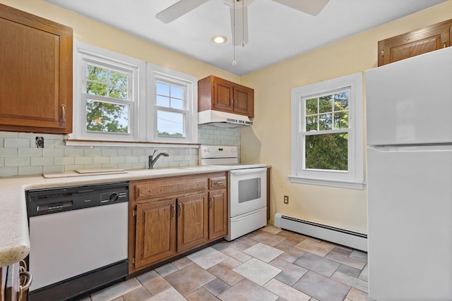 803 Oakwood Dr, Peekskill, NY 10566 - kitchen featuring white appliances, a baseboard heating unit, a sink, light countertops, and decorative backsplash