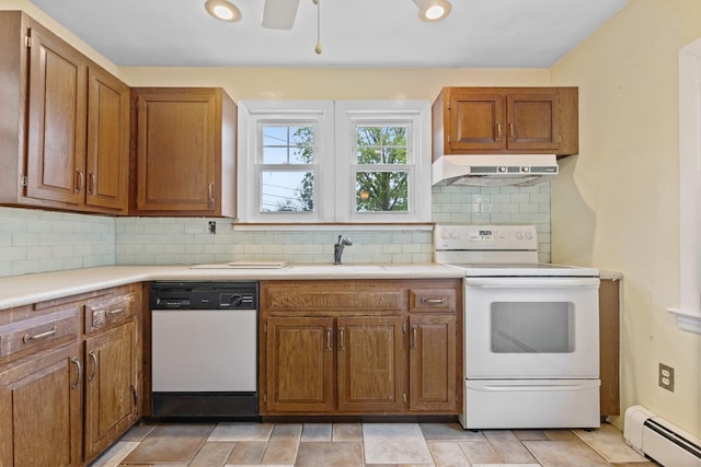 803 Oakwood Dr, Peekskill, NY 10566 - kitchen featuring white appliances, baseboard heating, under cabinet range hood, a sink, and light countertops