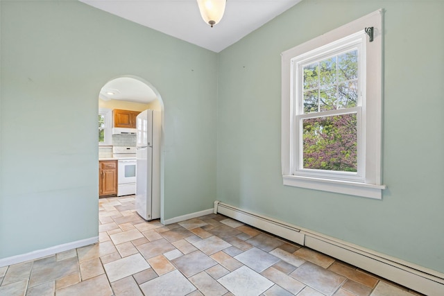 803 Oakwood Dr, Peekskill, NY 10566 - unfurnished room with a baseboard heating unit, healthy amount of natural light, baseboards, and arched walkways