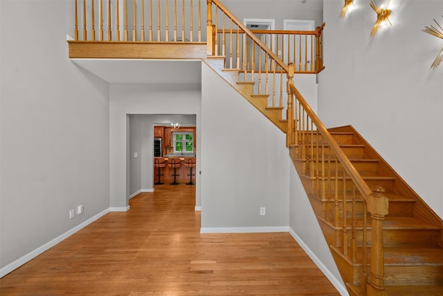 9 Hill Rd, Washingtonville, NY 10992 - stairs featuring wood finished floors, baseboards, and a high ceiling