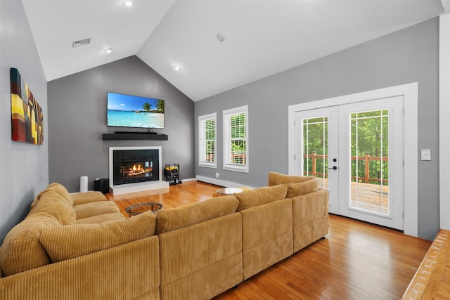 9 Hill Rd, Washingtonville, NY 10992 - living room featuring a glass covered fireplace, light wood finished floors, high vaulted ceiling, plenty of natural light, and recessed lighting