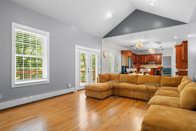 9 Hill Rd, Washingtonville, NY 10992 - living area with light wood finished floors, a chandelier, a baseboard heating unit, high vaulted ceiling, and healthy amount of natural light