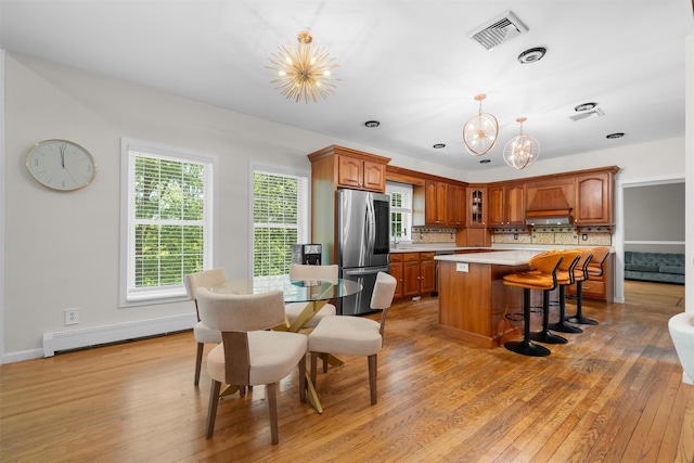 9 Hill Rd, Washingtonville, NY 10992 - kitchen featuring a chandelier, smart refrigerator, light countertops, light wood-type flooring, and tasteful backsplash