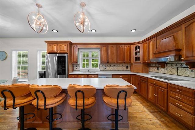 9 Hill Rd, Washingtonville, NY 10992 - kitchen with appliances with stainless steel finishes, a sink, custom exhaust hood, light wood-type flooring, and light countertops