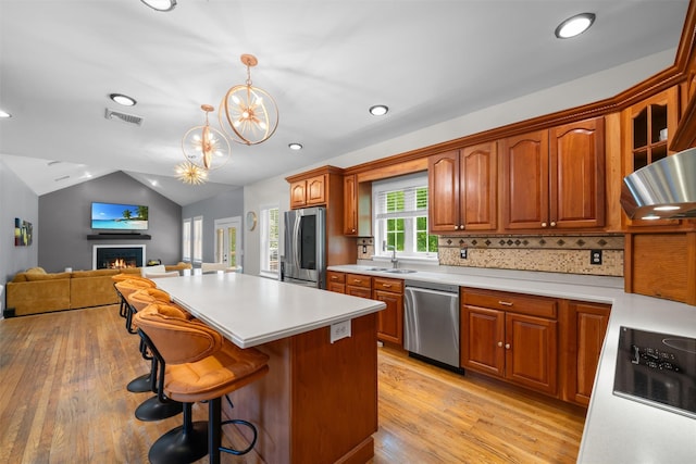 9 Hill Rd, Washingtonville, NY 10992 - kitchen featuring stainless steel appliances, a sink, light wood-type flooring, light countertops, and a chandelier