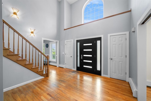 9 Hill Rd, Washingtonville, NY 10992 - entrance foyer with a towering ceiling, hardwood / wood-style flooring, stairway, a baseboard heating unit, and baseboards