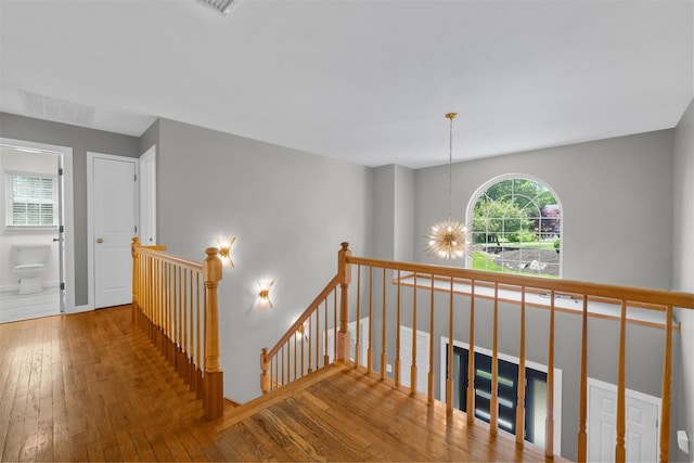 9 Hill Rd, Washingtonville, NY 10992 - hallway with an upstairs landing, hardwood / wood-style floors, a chandelier, and baseboards