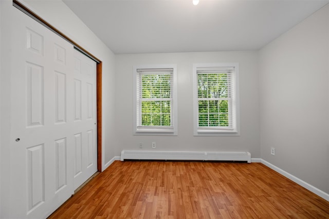 9 Hill Rd, Washingtonville, NY 10992 - unfurnished bedroom with baseboard heating, light wood finished floors, baseboards, and a closet