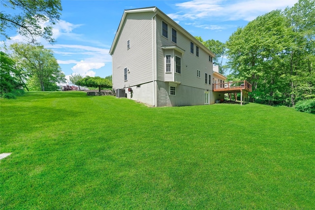 9 Hill Rd, Washingtonville, NY 10992 - back of property with a yard, central AC unit, and a wooden deck