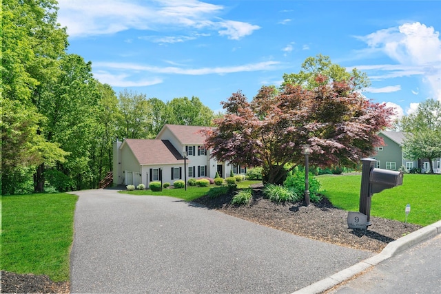 9 Hill Rd, Washingtonville, NY 10992 - colonial house featuring a front lawn, a chimney, and asphalt driveway