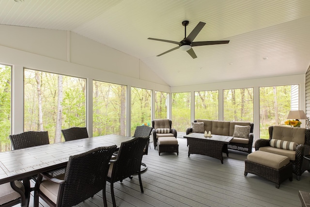 sunroom featuring ceiling fan, vaulted ceiling, an outdoor living space, and outdoor dining space
