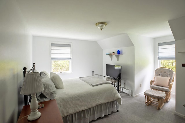carpeted bedroom with baseboard heating and baseboards
