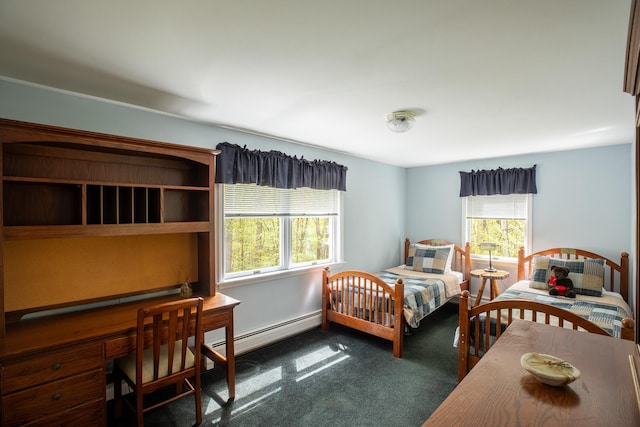 carpeted bedroom featuring a baseboard radiator and an office area