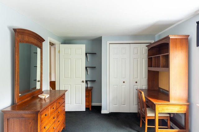 office area featuring dark carpet and baseboards