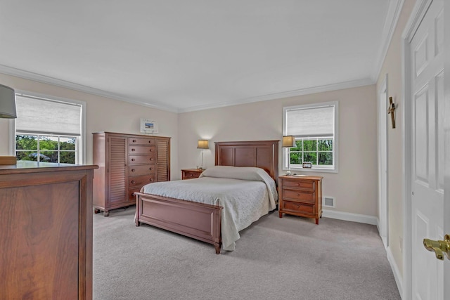 bedroom with light carpet, multiple windows, ornamental molding, and baseboards