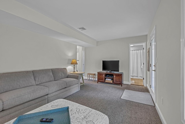 living room featuring carpet and baseboards