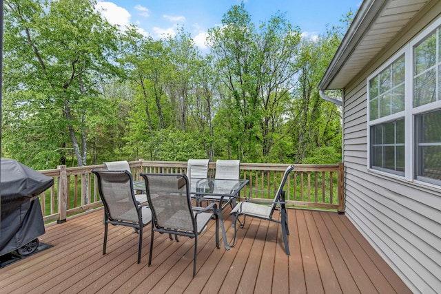 wooden deck featuring outdoor dining space and grilling area