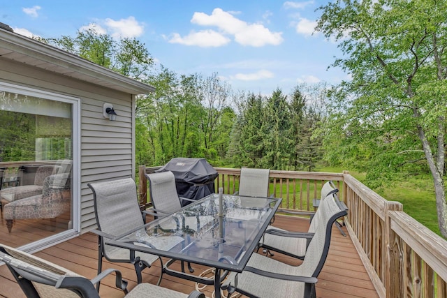 wooden terrace with outdoor dining space and grilling area