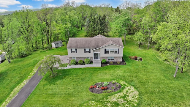 view of subject property with a heavily wooded area