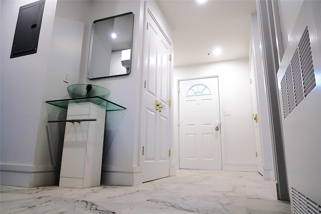entryway featuring light marble finish flooring and baseboards