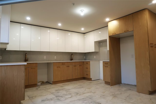 kitchen with light marble finish flooring, decorative backsplash, modern cabinets, white cabinets, and recessed lighting
