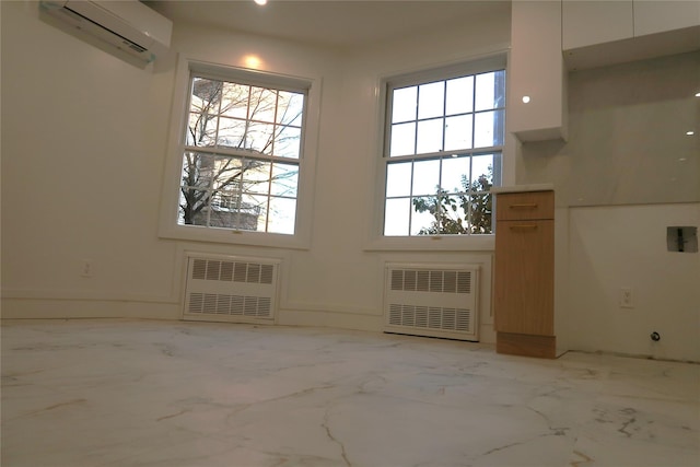 doorway featuring radiator, a wall mounted air conditioner, and marble finish floors