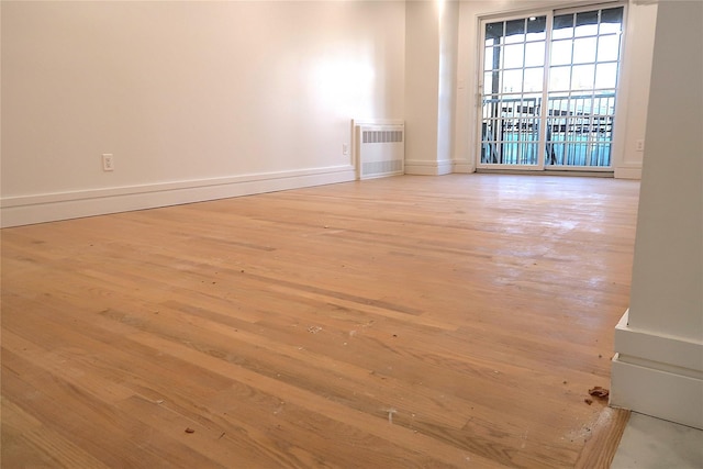 empty room with light wood-type flooring and baseboards