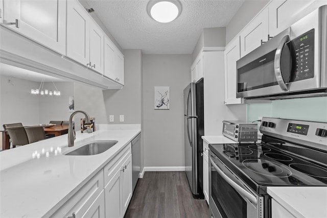 25 Rockledge Ave Unit 501, White Plains, NY 10601 - kitchen with stainless steel appliances, a sink, light countertops, dark wood-type flooring, and baseboards