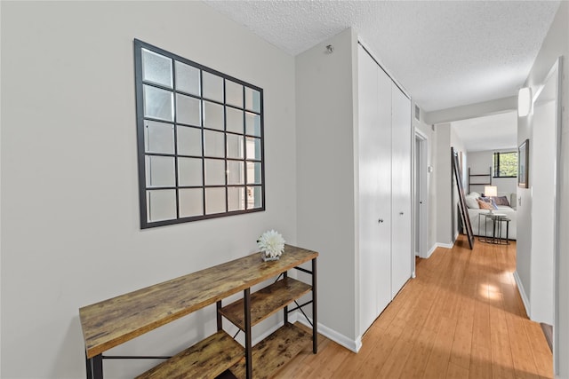 25 Rockledge Ave Unit 501, White Plains, NY 10601 - hallway with light wood-style flooring, baseboards, and a textured ceiling