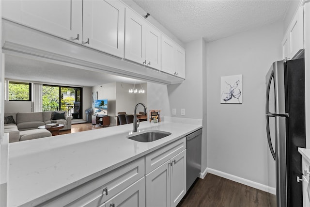 25 Rockledge Ave Unit 501, White Plains, NY 10601 - kitchen with a sink, appliances with stainless steel finishes, white cabinets, dark wood-style floors, and open floor plan