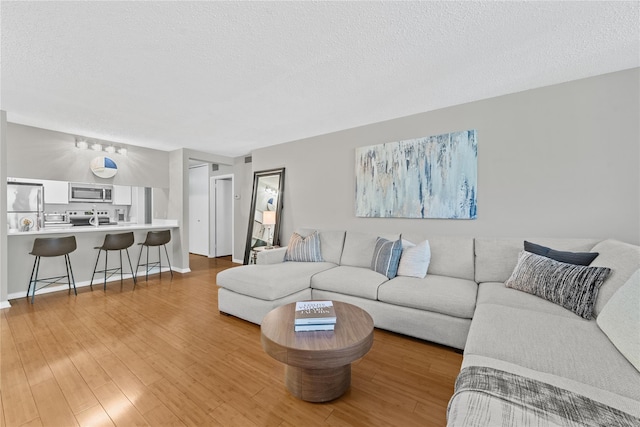 25 Rockledge Ave Unit 501, White Plains, NY 10601 - living room featuring light wood finished floors and a textured ceiling