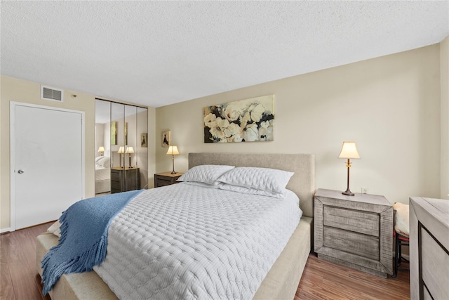 25 Rockledge Ave Unit 501, White Plains, NY 10601 - bedroom featuring wood finished floors, a closet, and a textured ceiling