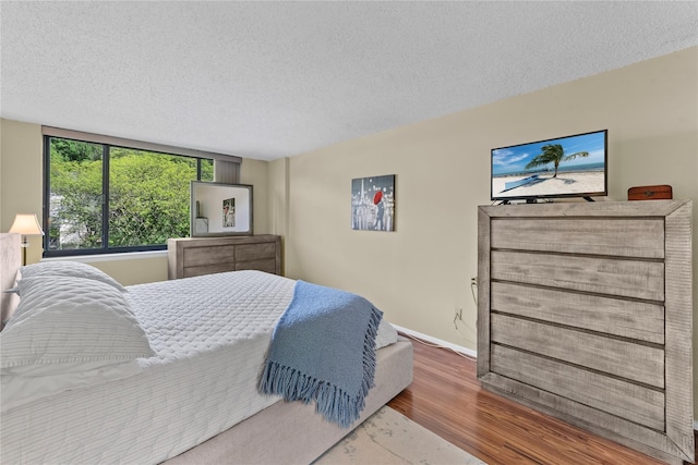 25 Rockledge Ave Unit 501, White Plains, NY 10601 - bedroom with wood finished floors, a textured ceiling, and baseboards
