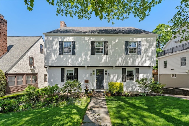 view of front of home featuring a front yard and a chimney