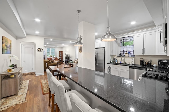 90 Bryant Ave Unit Ftd, White Plains, NY 10605 - kitchen featuring stainless steel appliances, a sink, white cabinets, plenty of natural light, and recessed lighting
