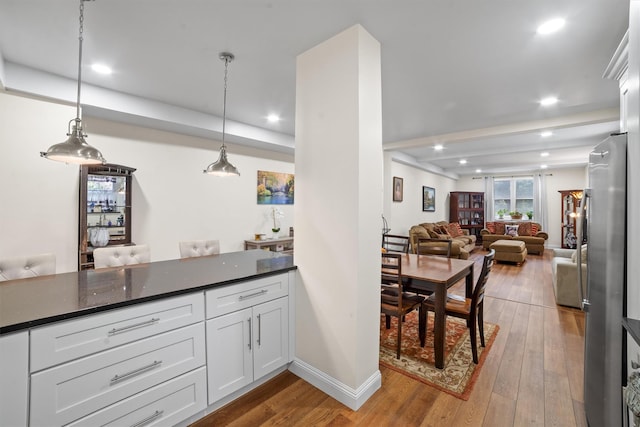 90 Bryant Ave Unit Ftd, White Plains, NY 10605 - kitchen featuring hardwood / wood-style flooring, recessed lighting, white cabinets, freestanding refrigerator, and open floor plan