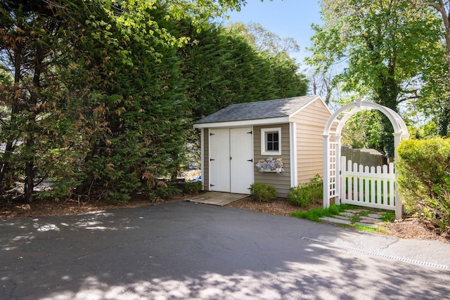 view of shed with fence