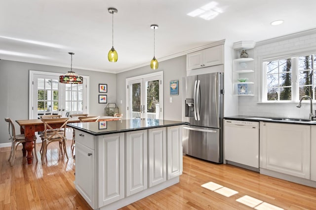 kitchen featuring stainless steel fridge with ice dispenser, white dishwasher, french doors, dark countertops, and light wood-style flooring