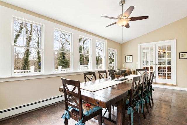 dining room featuring baseboard heating, plenty of natural light, french doors, vaulted ceiling, and tile patterned floors