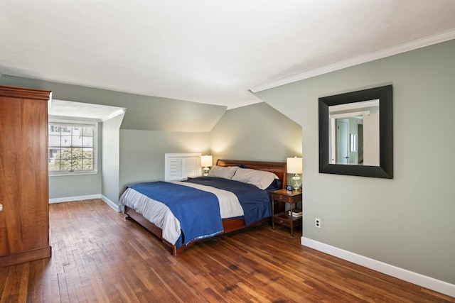 bedroom featuring baseboards, ornamental molding, dark wood-style floors, and vaulted ceiling