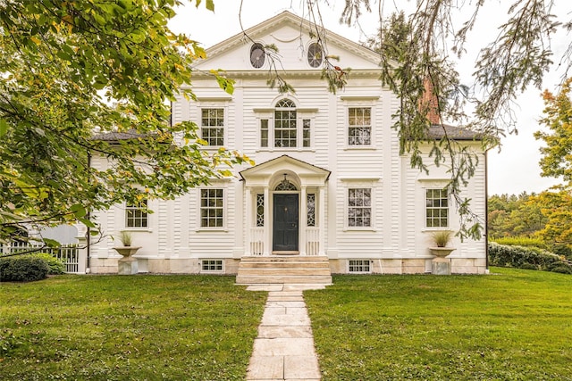 neoclassical / greek revival house featuring a front lawn