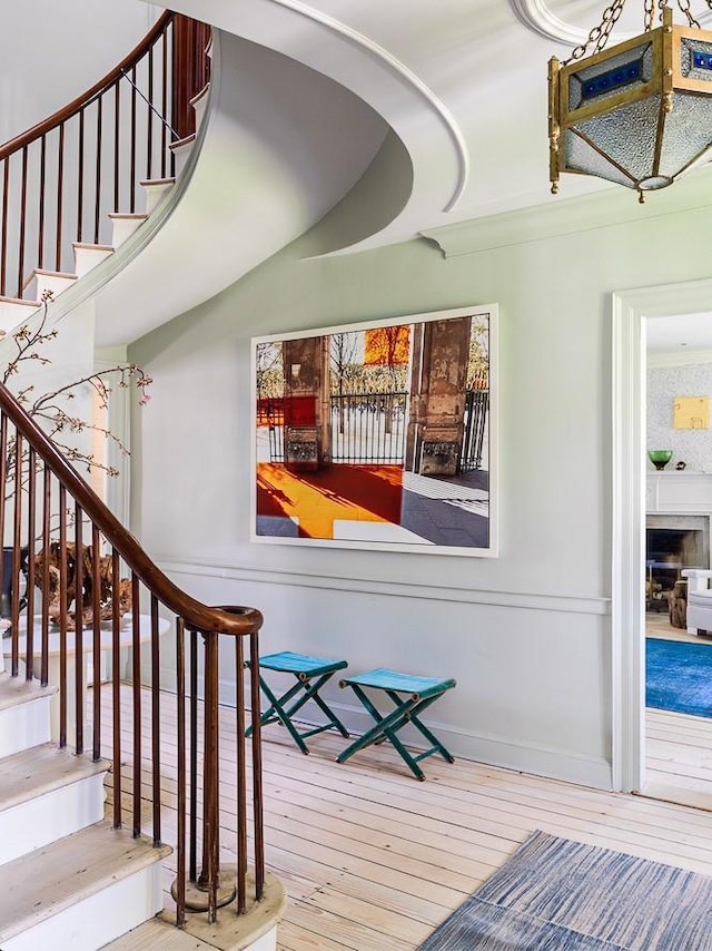 stairway featuring wood-type flooring and baseboards