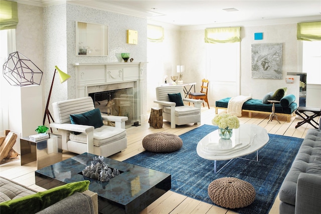 living room with hardwood / wood-style flooring, ornamental molding, and a fireplace