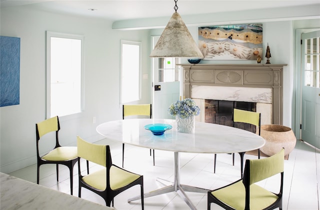 dining space with a premium fireplace and baseboards