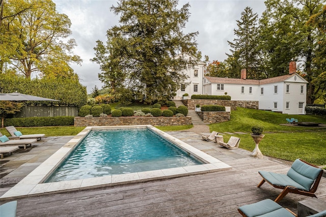 swimming pool with a deck and a patio area