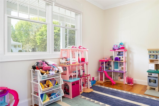 1145 Bay Haven Ln, Southold, NY 11971 - playroom with healthy amount of natural light, wood finished floors, ornamental molding, and baseboards